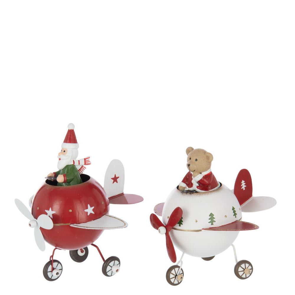 Two decorative airplane-shaped ornaments on a plain white background. One is red with white stars and a Santa Claus figure in the cockpit.