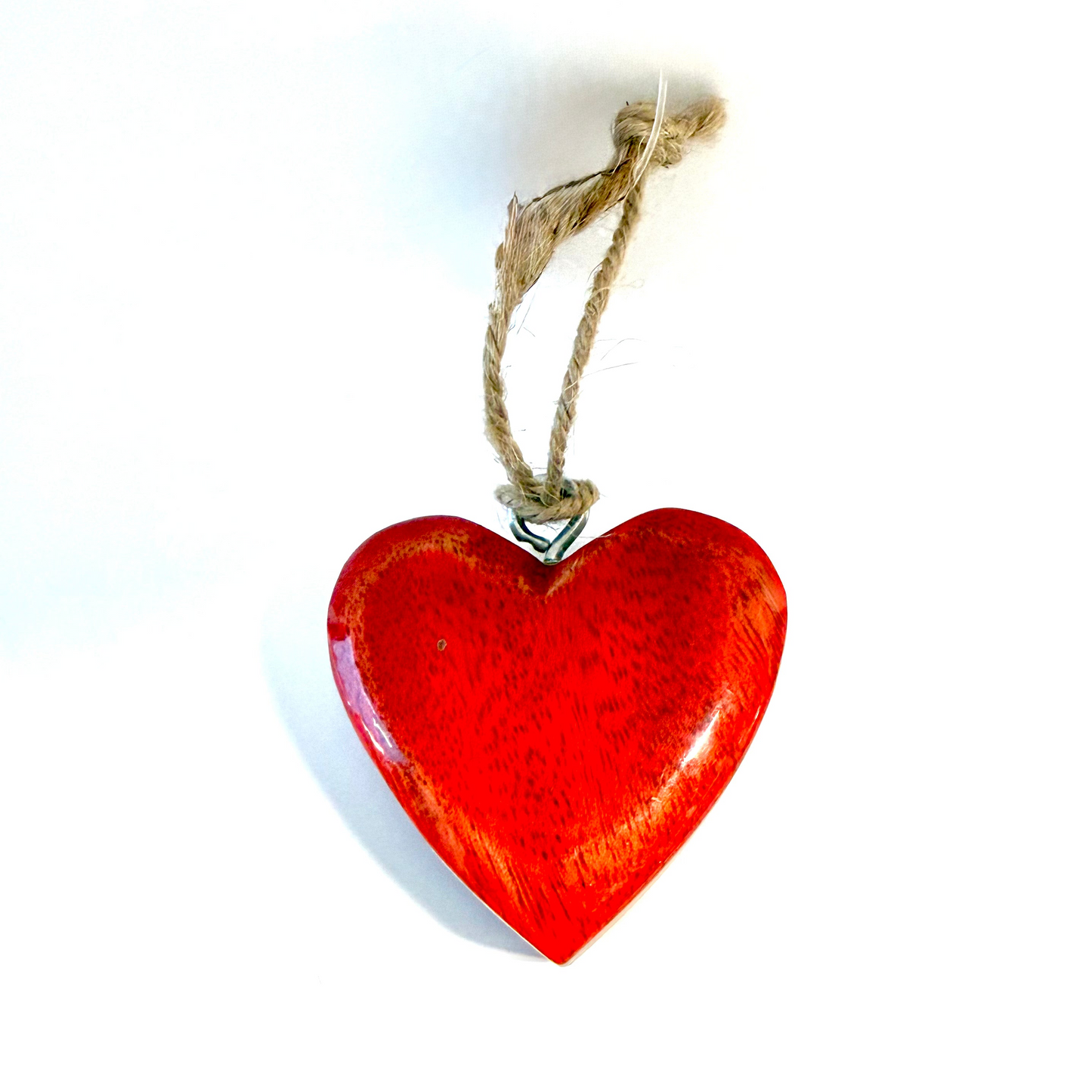 A glossy red heart-shaped wooden ornament with a natural jute hanging string, shown against a plain white background.