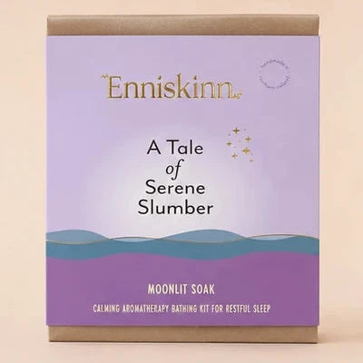 The Enniskinn 'A Tale of Serene Slumber' Moonlit Soak packaging box, featuring a lavender and purple design with gold and black text, set against a solid beige background.