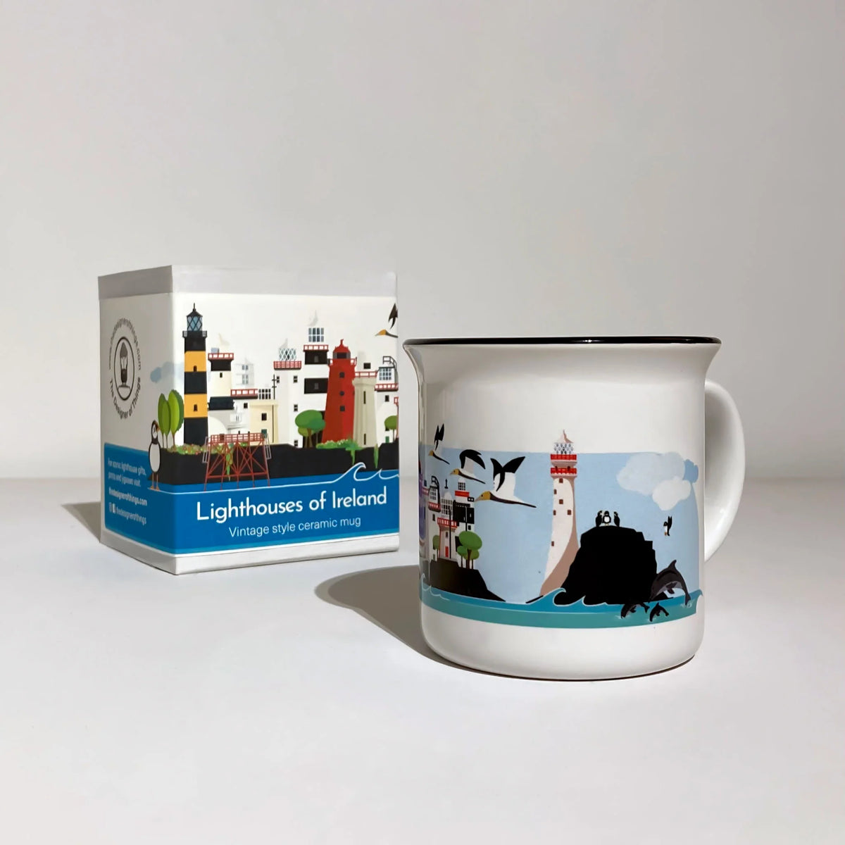 Ceramic mug with lighthouse design and packaging labeled 'Lighthouses of Ireland' on a white background