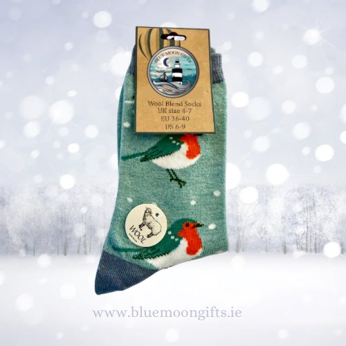 A single pair of blue and green wool blend socks with a hangtag, featuring a robin and a red grouse design, set against a snowy winter background.
